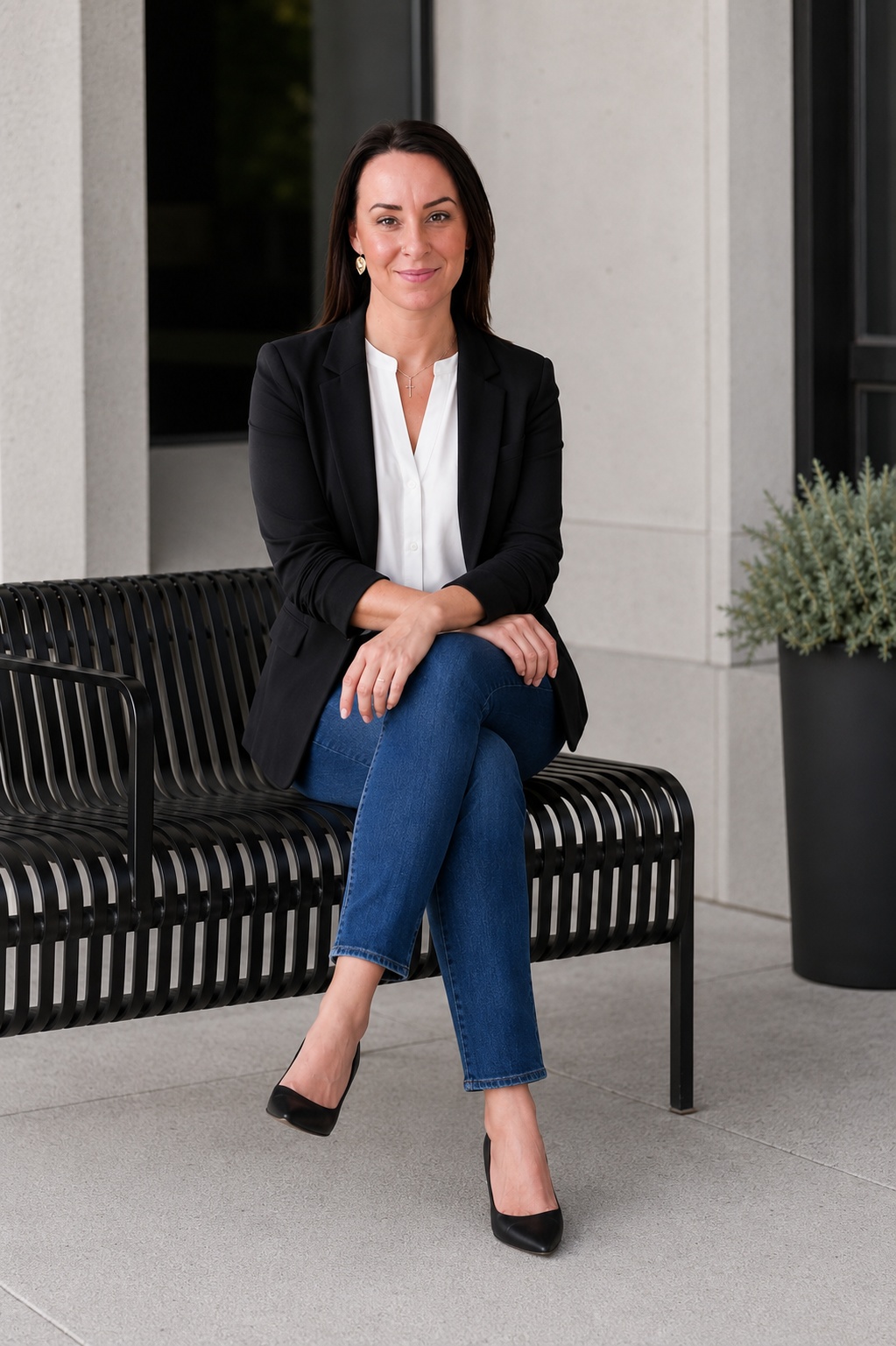 Britney Auclair, Calgary REALTOR®, seated on a bench